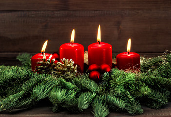 advent decoration with four red burning candles
