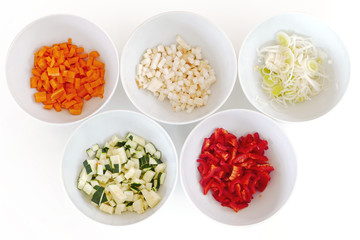 chopped vegetables in white bowls, cooking preparation