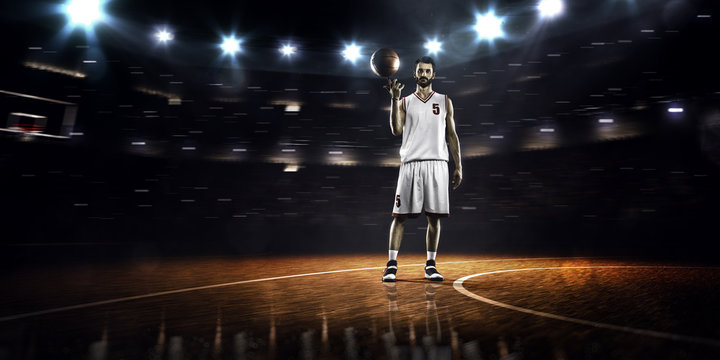 Basketball player is spinning ball around the finger