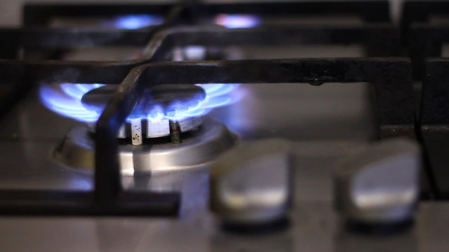 Gas stove with a burning flame