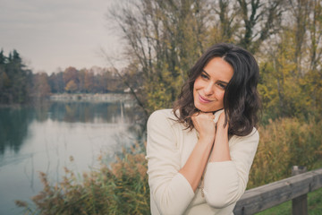 Beautiful young woman posing in a city park