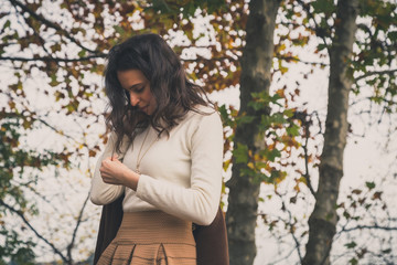 Beautiful young woman posing in a city park