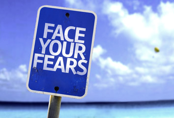 Face Your Fears sign with a beach on background