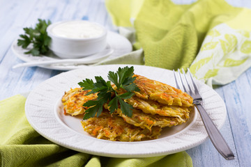 Vegetable fritters with cabbage and carrots on a blue background