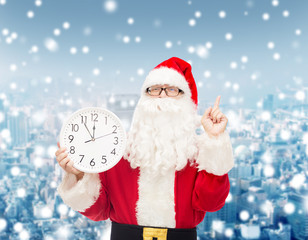 man in costume of santa claus with clock