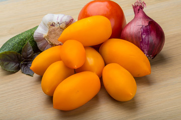 Yellow tomatoes on the board