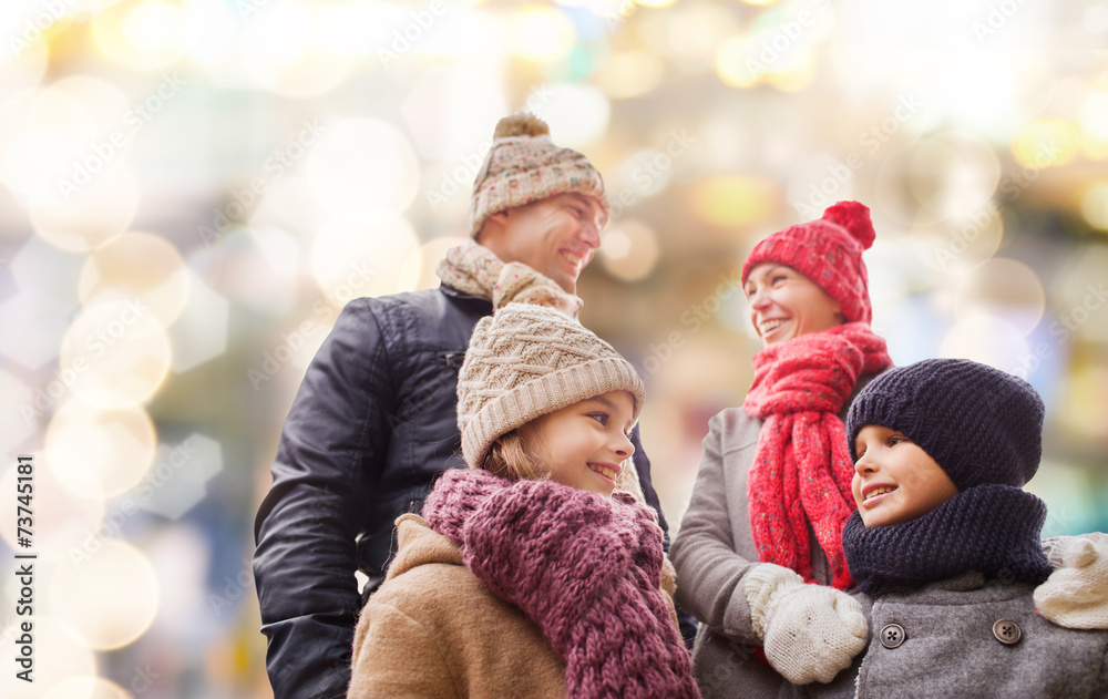 Wall mural happy family in winter clothes outdoors