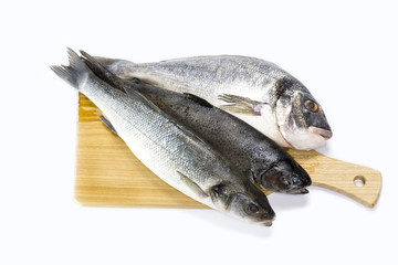 raw fish on a cutting board and knife