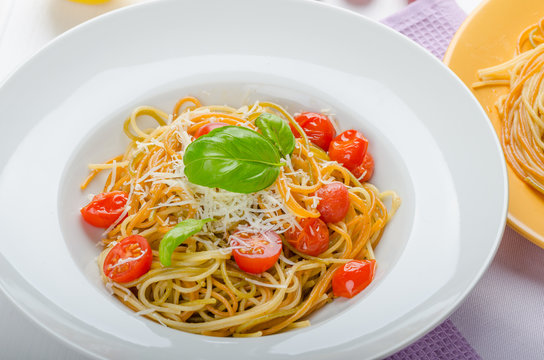Lemon pasta with cherry tomatoes, basil and nuts