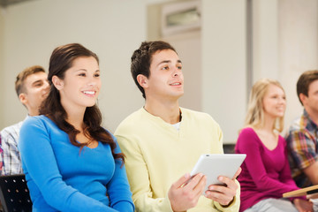 group of smiling students with tablet pc