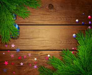 wooden background with branches of a Christmas tree.