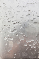 Metal surface covered in water drops.
