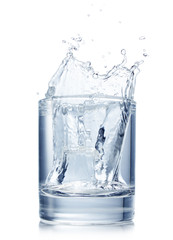 Splash from ice cube in glass of water
