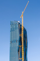 The construction of a high-rise building. Tower crane.