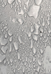 Metal surface covered in water drops.