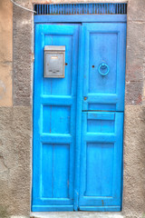 blue wooden door in a rustic wall