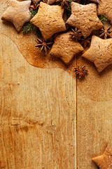 Christmas gingerbread stars on wooden background