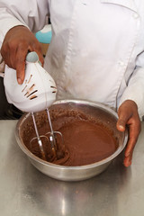 Pastry chef mixing cake mixture
