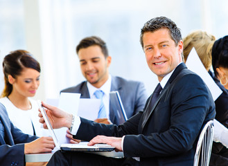 Portrait of young handsome businessman in office