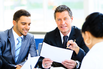 Image of business partners discussing documents