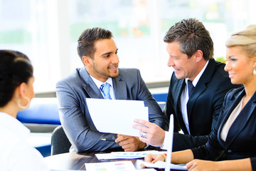 Image of business partners discussing documents