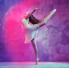 Poster Flexible young ballet dancer on the dance floor © konradbak