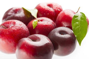 Red plums isolated on white background