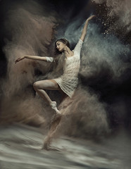 Dancing ballet dancer with dust in the background