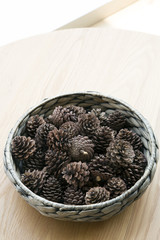 The cones ornament in woven bowl