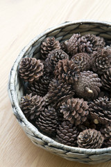 The cones ornament in woven bowl
