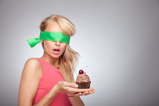 Blonde girl with cake posing