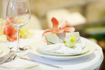 Elegant table set in soft creme for wedding or event party.