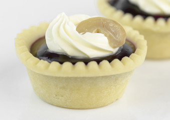 tart vanilla cream with cashew nut on white background