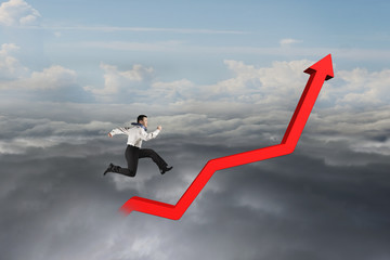 Businessman running on red growth trend line