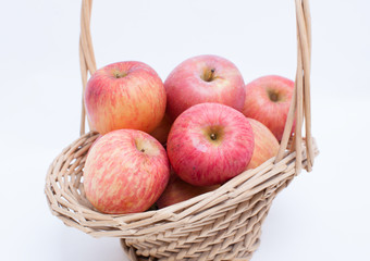 apples in a basket on white background