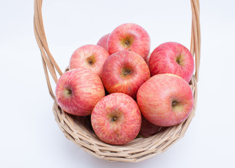 apples in a basket on white background