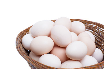 Eggs in basket isolated on white background