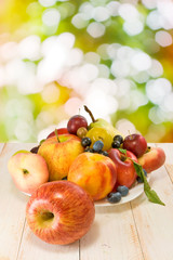 different fruits on a plate on a blurred background