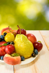 different fruits on a plate on a blurred background