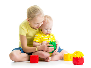 baby boy playing together with sister