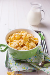 Cornflakes in bowl on table