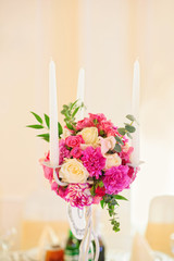 Flower composition with candles for an event party or
