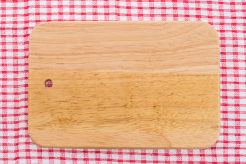 wood cutting board on tablecloth