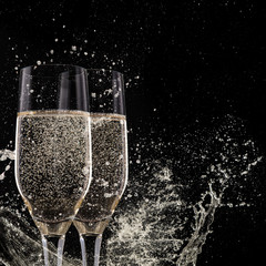 Champagne flutes on black background