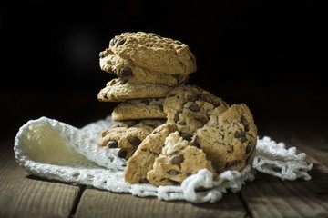 chocolate cookie with white lace napkin on wooden table