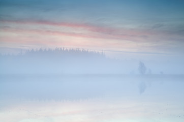 Obraz na płótnie Canvas misty sunrise over lake