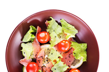 Appetizing fish salad with vegetables on plate isolated on