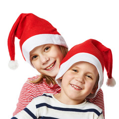 Girl and little boy in Santa Claus hat