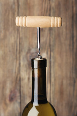 Bottle opener close-up, on wooden background