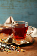 Beautiful vintage composition with herbal tea, on wooden table